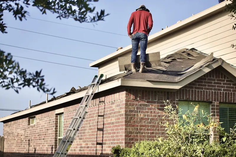 Professional roofer working on a residential roof in South Franklinton